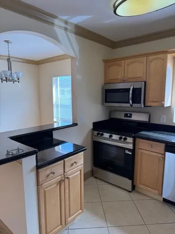 a kitchen with granite countertop a stove and a sink