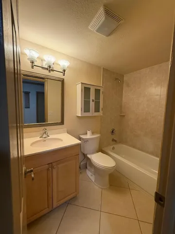a white toilet sitting next to a bathroom sink