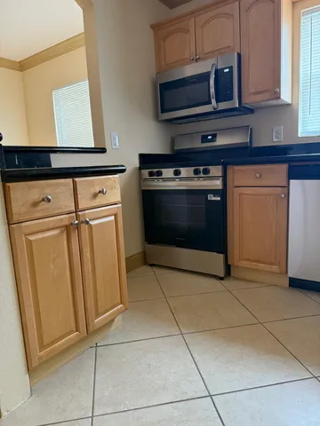a stove top oven sitting inside of a kitchen