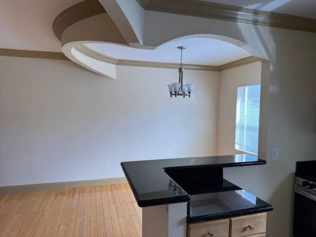 a room with wooden floor and windows