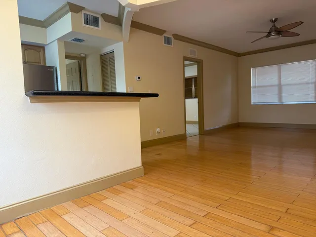 a view of a livingroom with an empty space and a window