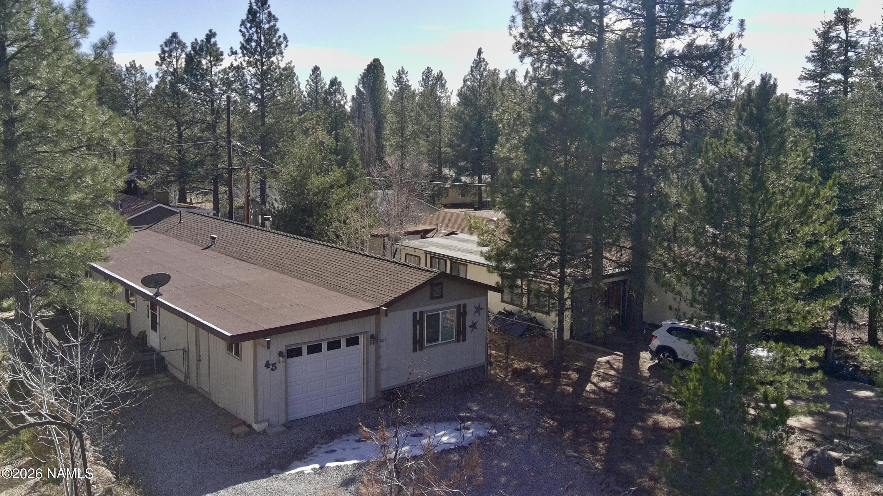 aerial view of a house with a yard