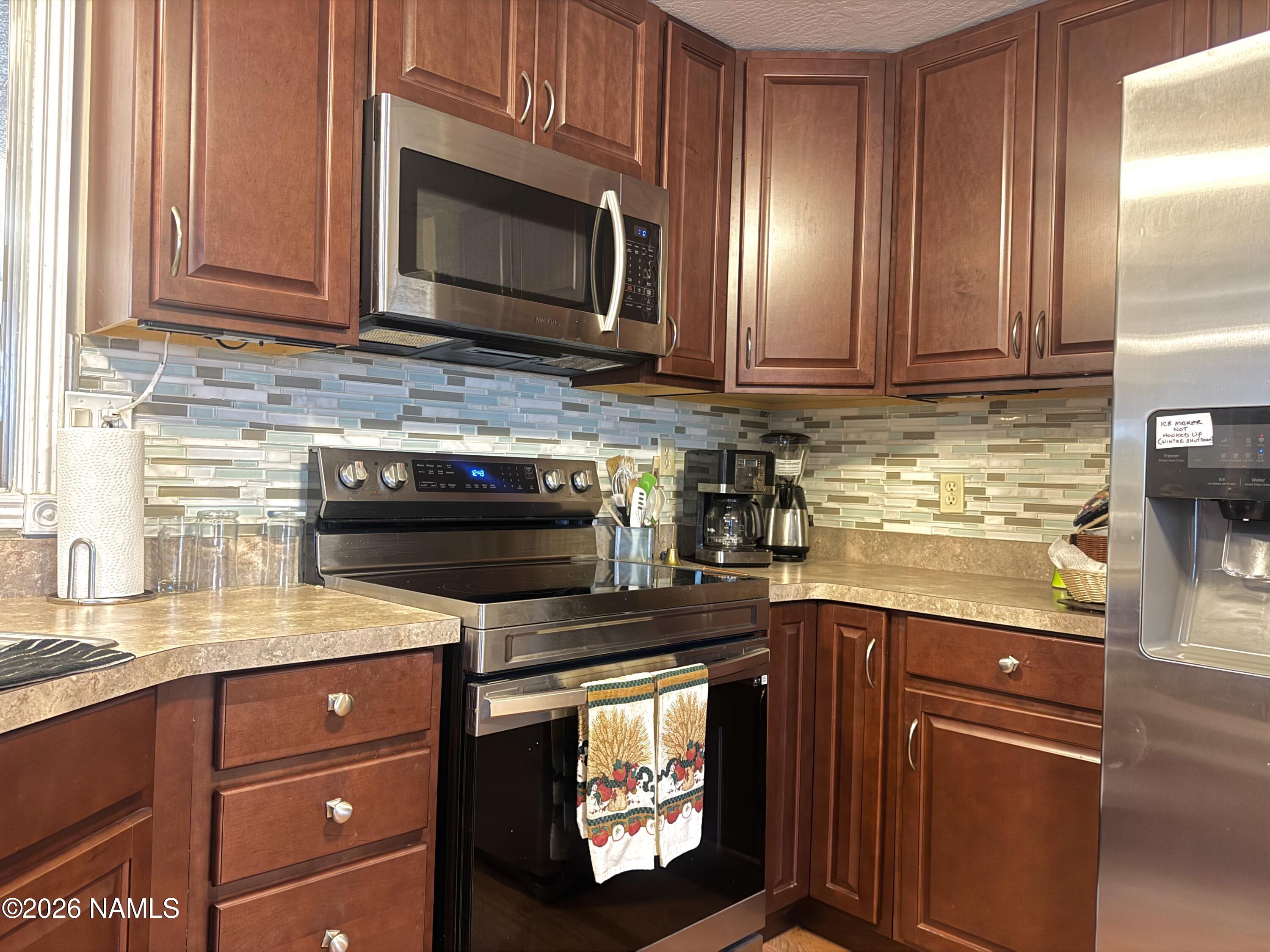 45 Fairlane Road Munds Park, AZ 86017 - Photo 11 of 24 a kitchen with granite countertop cabinets stainless steel appliances and a counter space