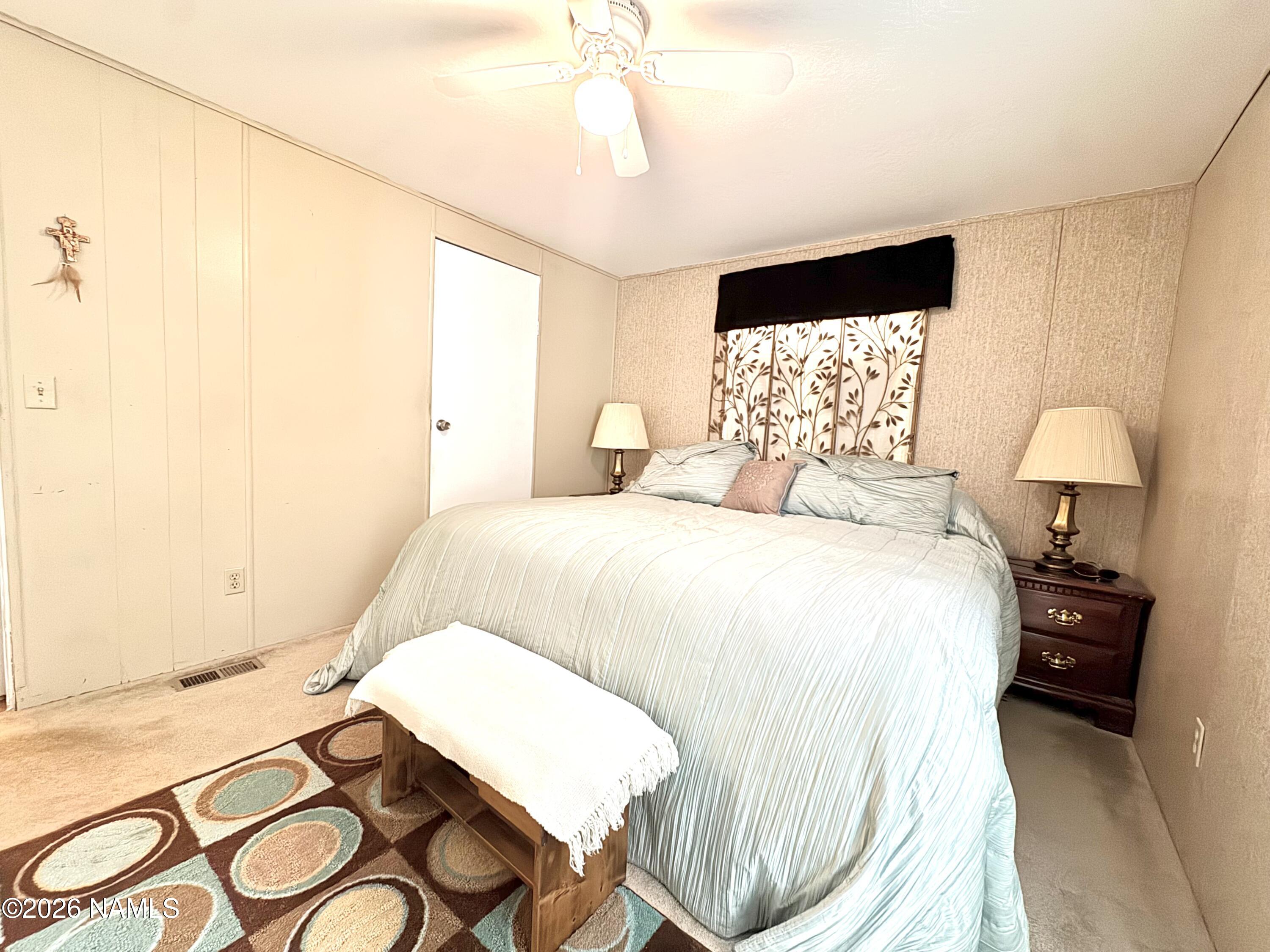 45 Fairlane Road Munds Park, AZ 86017 - Photo 14 of 24 a bedroom with a bed and a chandelier