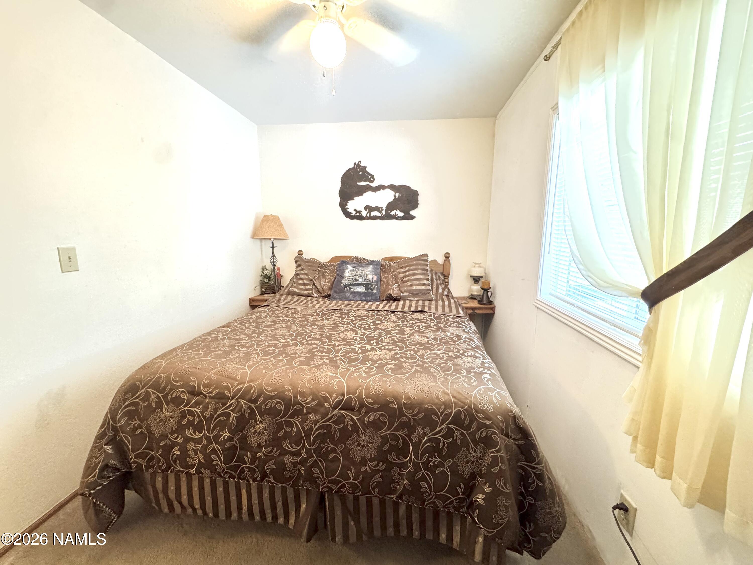 45 Fairlane Road Munds Park, AZ 86017 - Photo 18 of 24 a bedroom with a bed and a window