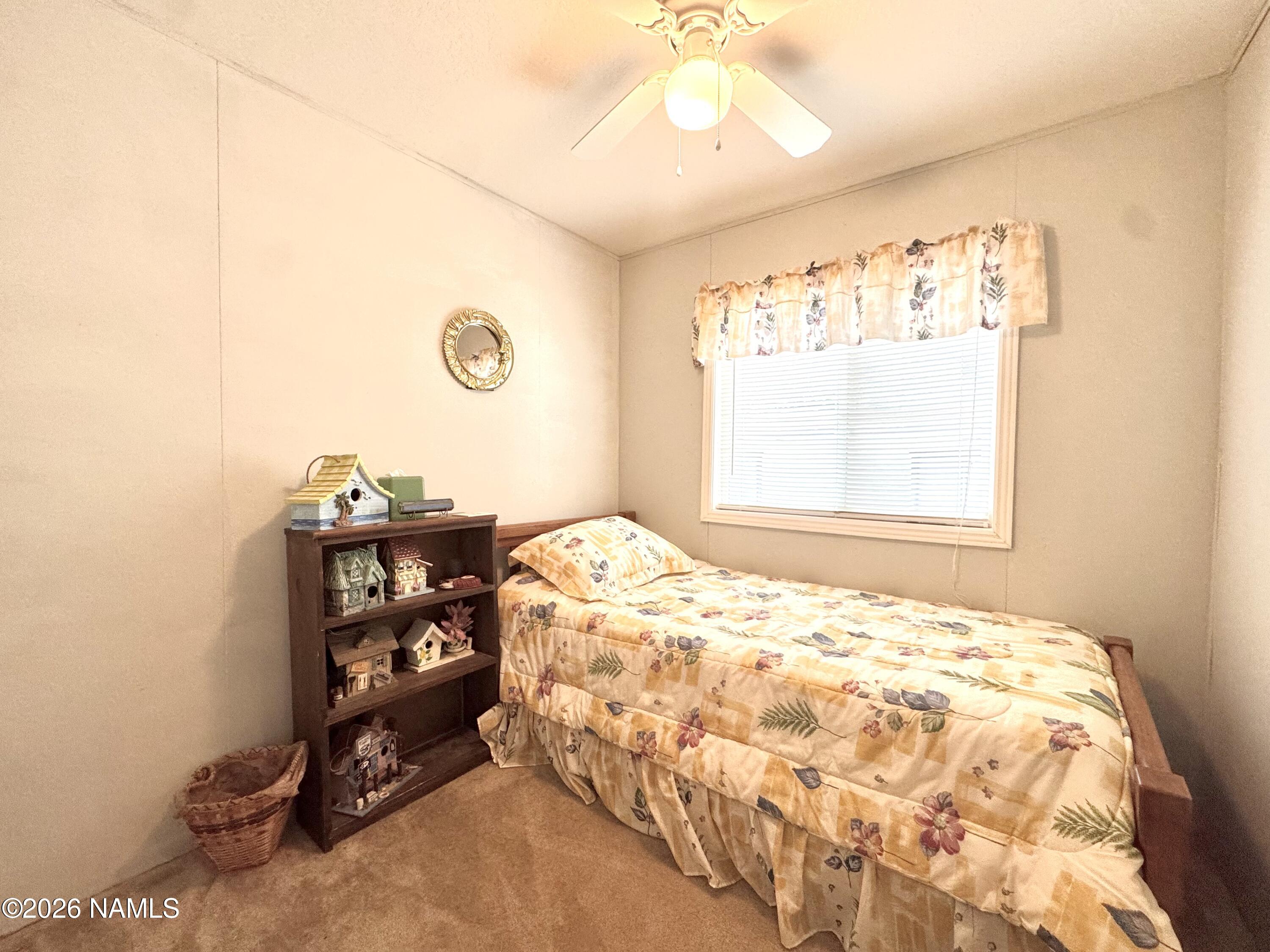 45 Fairlane Road Munds Park, AZ 86017 - Photo 20 of 24 a bedroom with a bed and a window