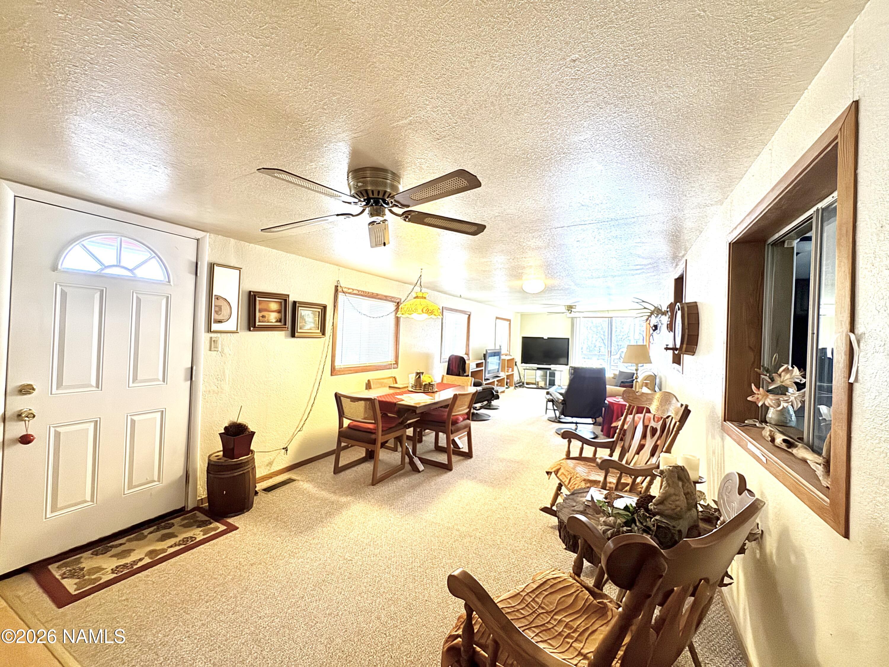 45 Fairlane Road Munds Park, AZ 86017 - Photo 4 of 24 a living room with furniture and a large window