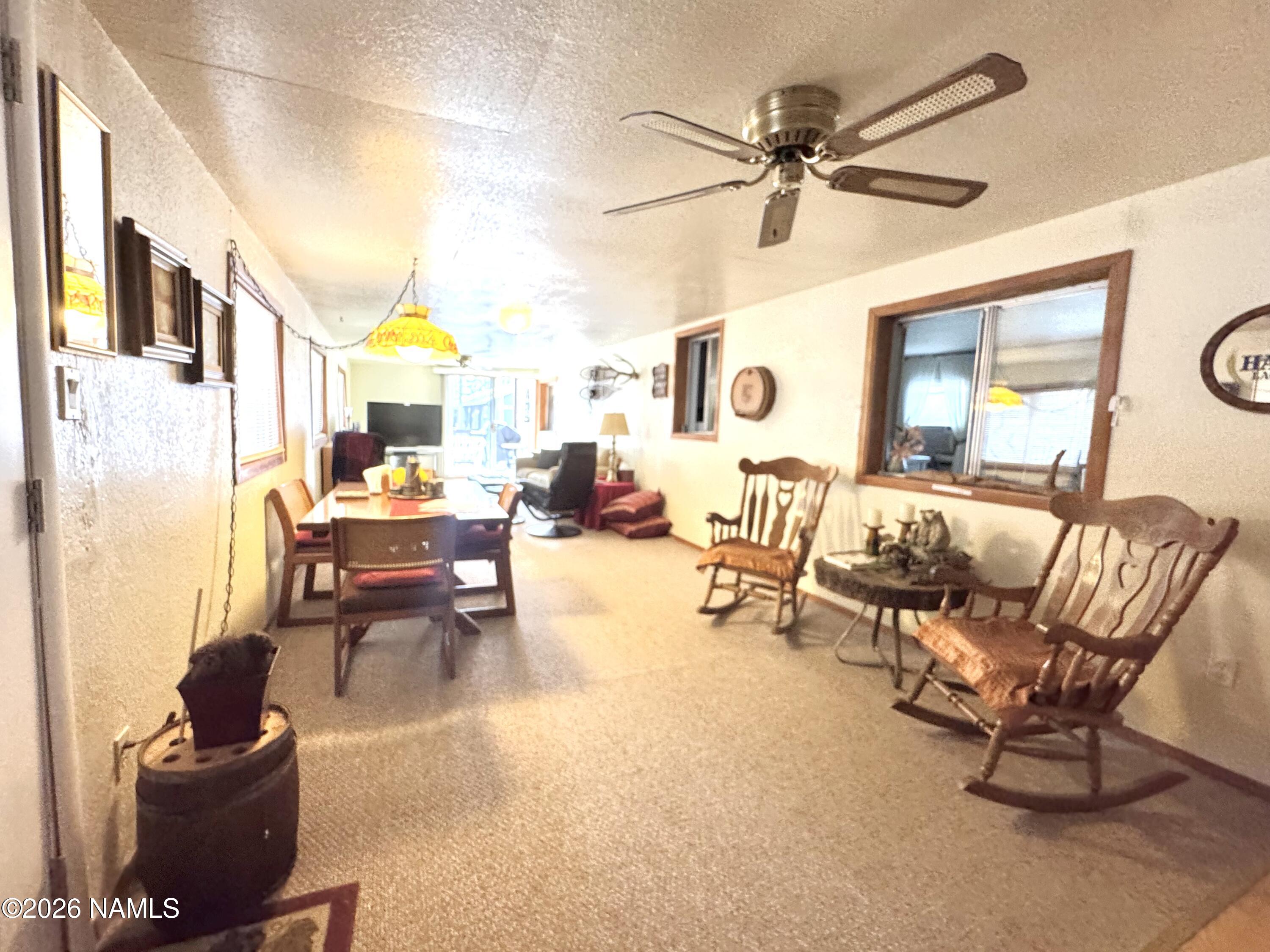 45 Fairlane Road Munds Park, AZ 86017 - Photo 6 of 24 a living room with furniture and a large window