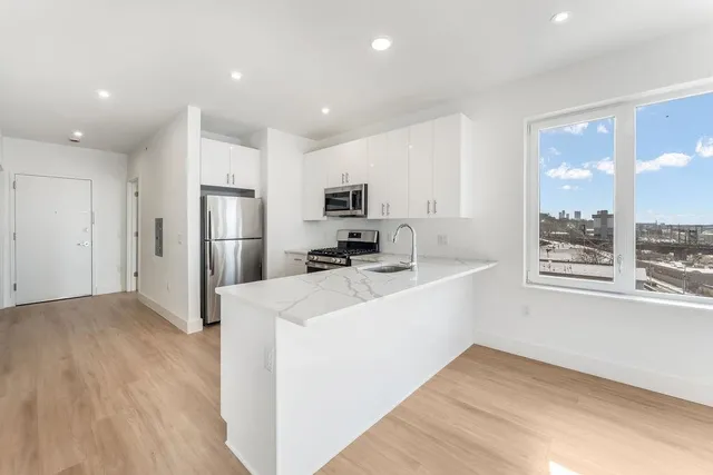 a view of a kitchen with electric appliances