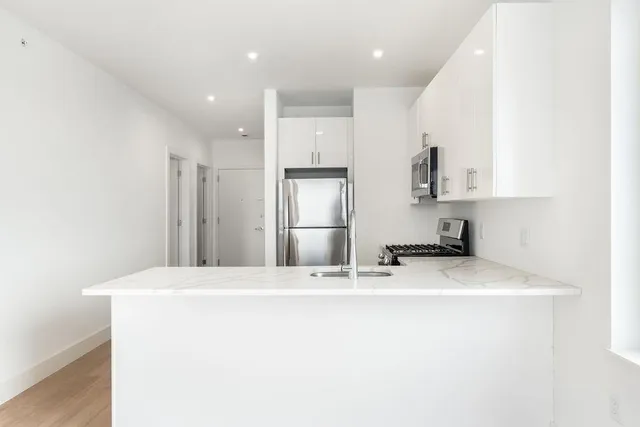 a kitchen with stainless steel appliances a refrigerator and a sink