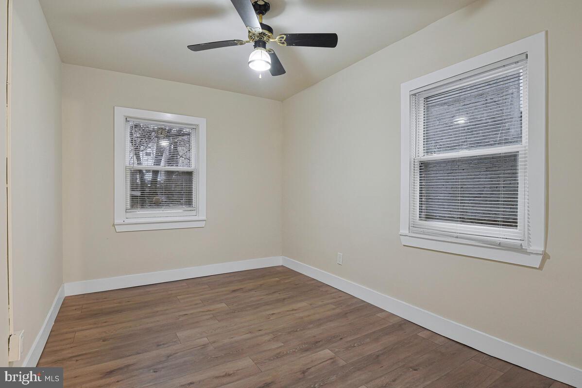 3427 B Street Southeast, Unit 2 Washington, DC 20019 - Photo 13 of 14 a view of an empty room with a window and wooden floor
