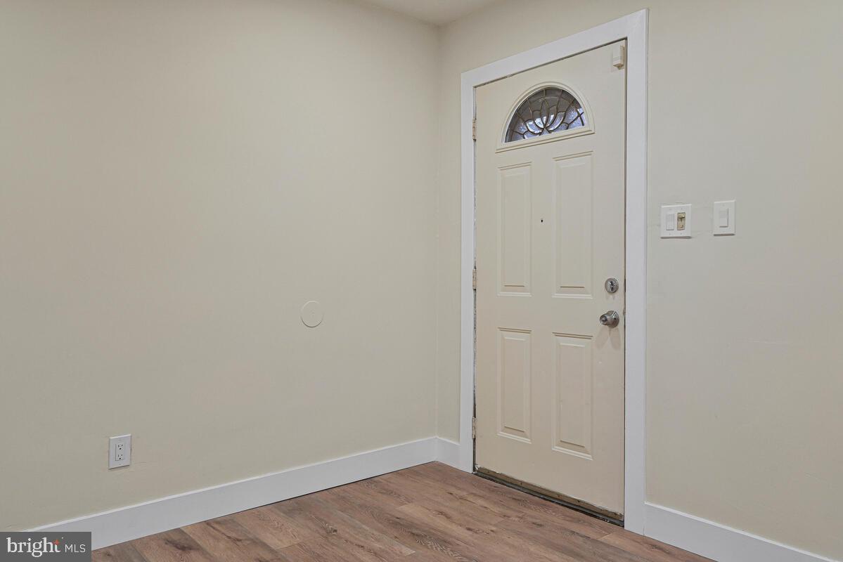 3427 B Street Southeast, Unit 2 Washington, DC 20019 - Photo 5 of 14 an empty room with wooden floor and closet