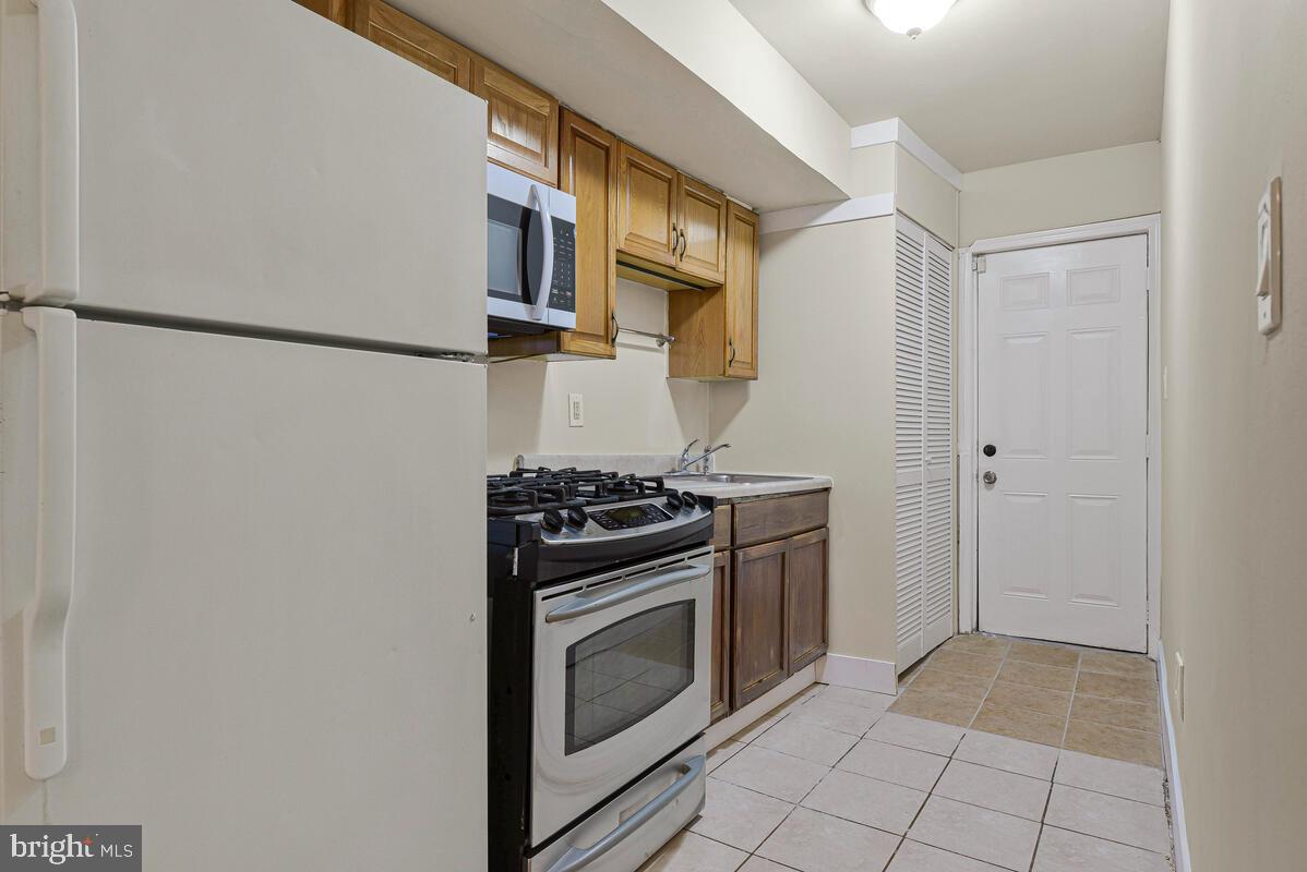 3427 B Street Southeast, Unit 2 Washington, DC 20019 - Photo 8 of 14 a kitchen with stainless steel appliances granite countertop a stove and a refrigerator