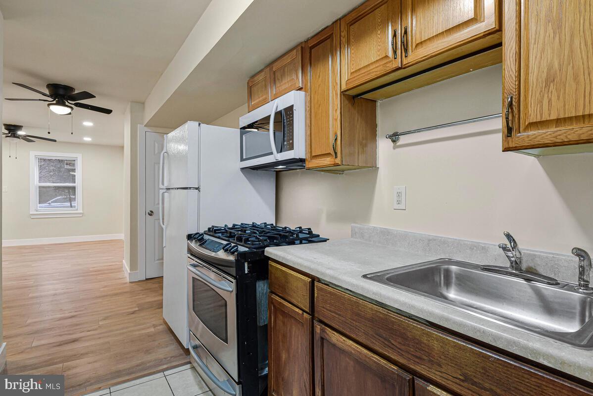 3427 B Street Southeast, Unit 2 Washington, DC 20019 - Photo 9 of 14 a kitchen with stainless steel appliances granite countertop a sink stove and cabinets