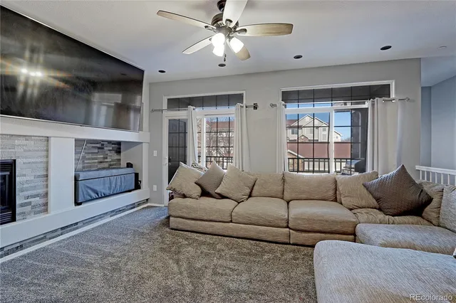 a living room with furniture and a fireplace