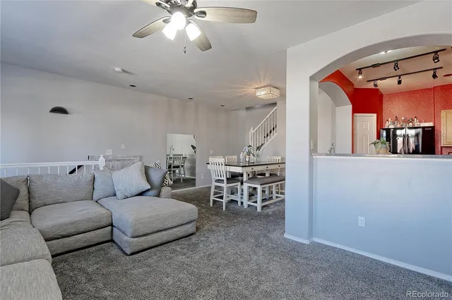 a living room with furniture and a large mirror