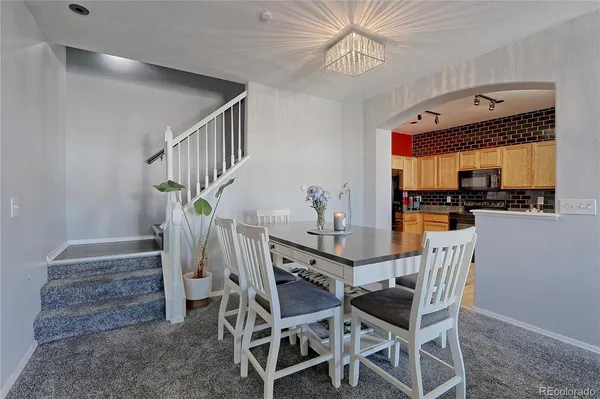 a view of a dining room with furniture and a chandelier