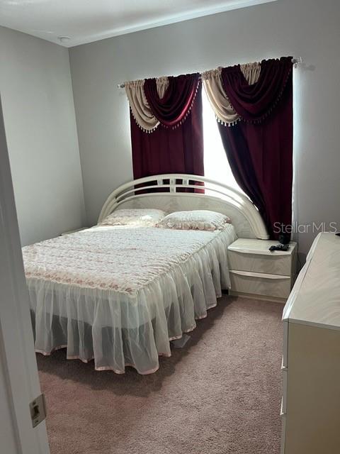 15610 Southwest 40th Terrace Ocala, FL 34473 - Photo 12 of 14 a bedroom with a bed and dresser