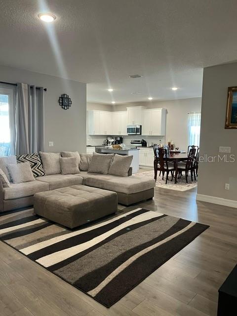 15610 Southwest 40th Terrace Ocala, FL 34473 - Photo 2 of 14 a living room with furniture and wooden floors