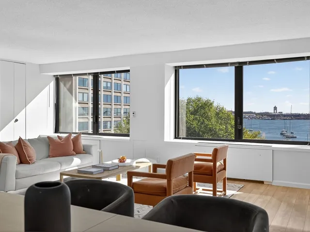 a living room with furniture and large windows