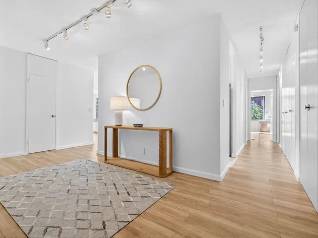 a view of a hallway with wooden floor