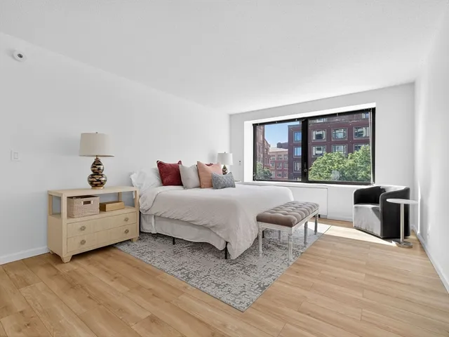 a spacious bedroom with a bed and a window