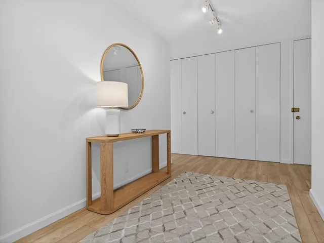 a view of a room with wooden floor and bathroom