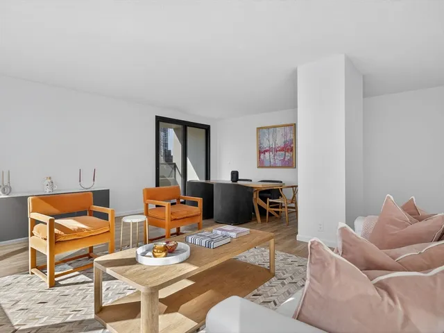 a living room with furniture a rug and a wall painting