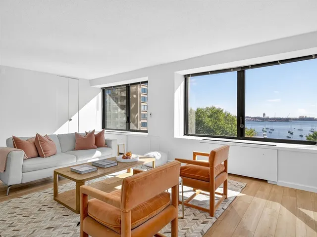a living room with furniture and large windows