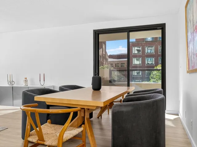 a view of a dining room with furniture and a window