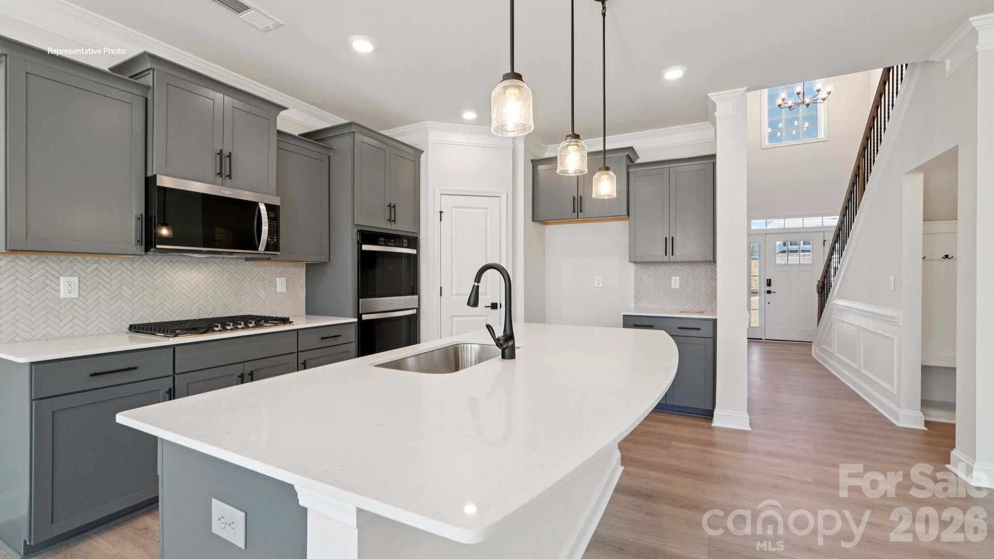 7609 Bainbridge Road Sherrills Ford, NC 28673 - Photo 11 of 36 a kitchen with stainless steel appliances a stove a sink a microwave and cabinets
