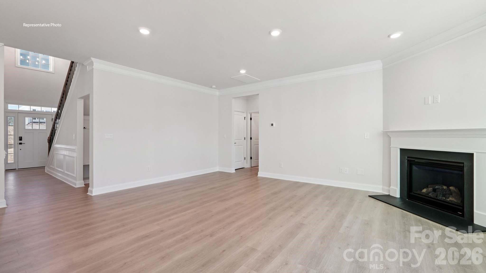 7609 Bainbridge Road Sherrills Ford, NC 28673 - Photo 16 of 36 a view of empty room with wooden floor and fireplace