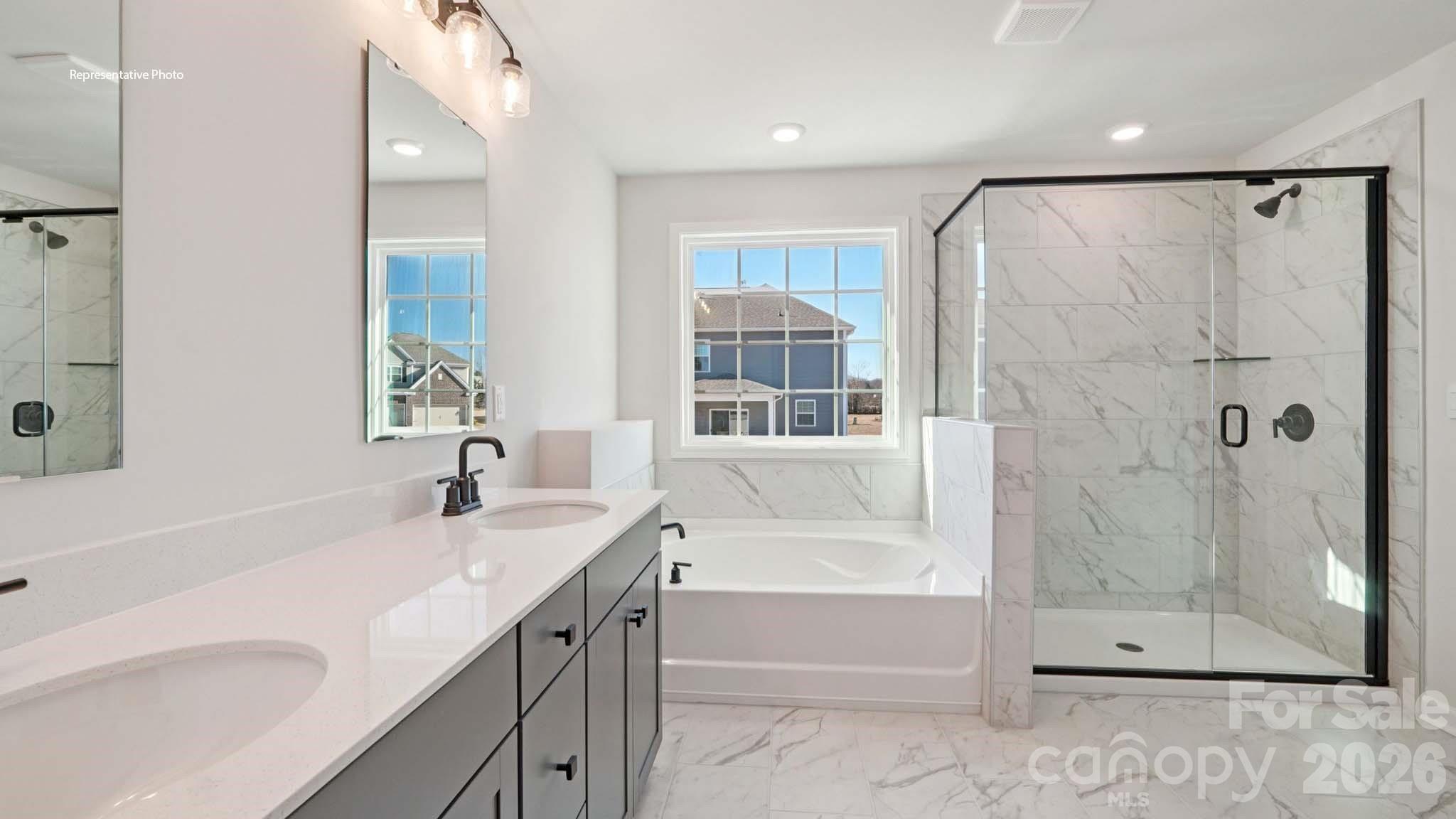 7609 Bainbridge Road Sherrills Ford, NC 28673 - Photo 29 of 36 a bathroom with a granite countertop sink a mirror shower and bathtub