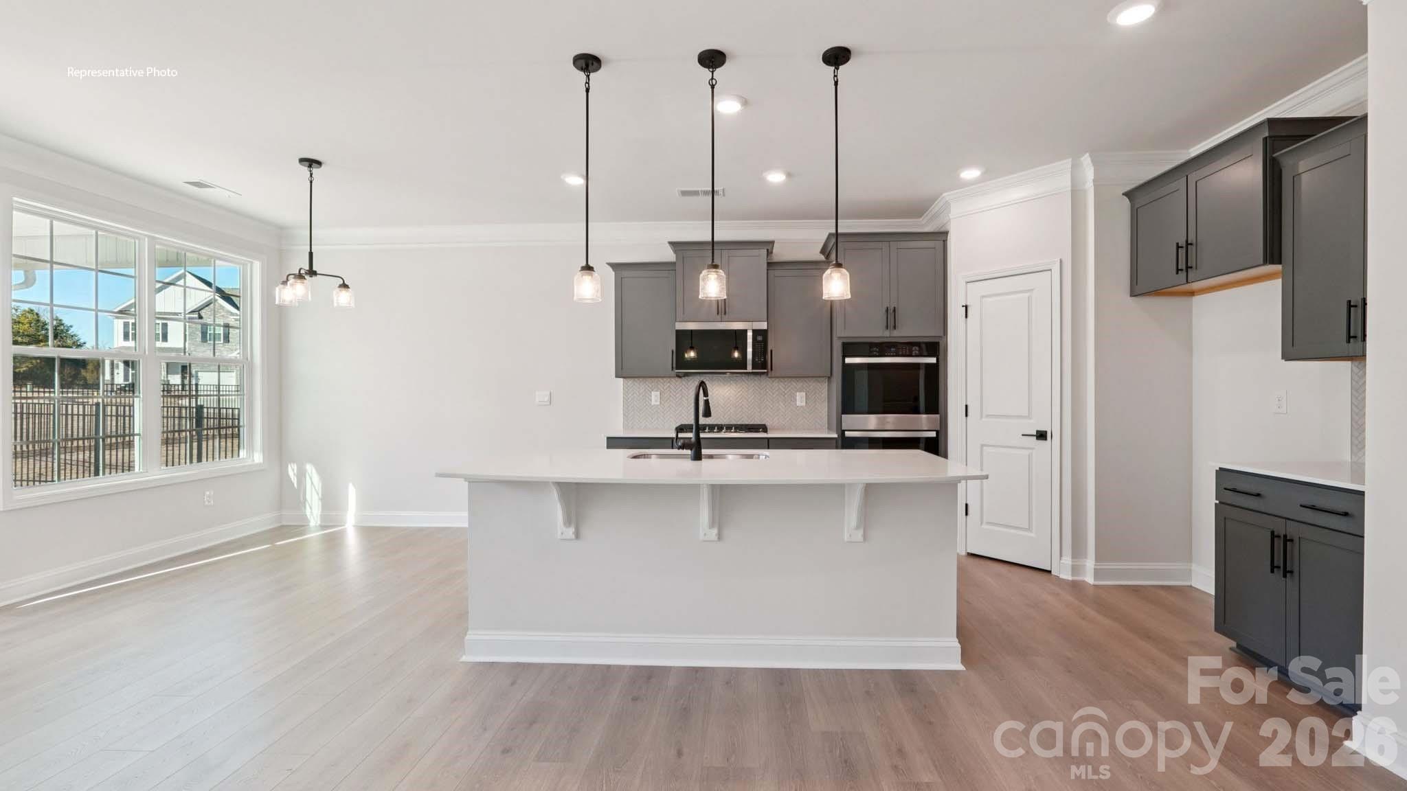 7609 Bainbridge Road Sherrills Ford, NC 28673 - Photo 10 of 36 a view of a kitchen with kitchen island a sink stainless steel appliances and cabinets