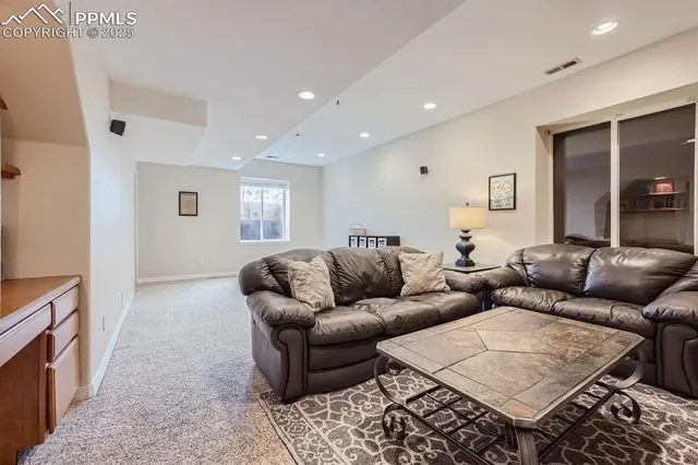 a living room with furniture and a rug