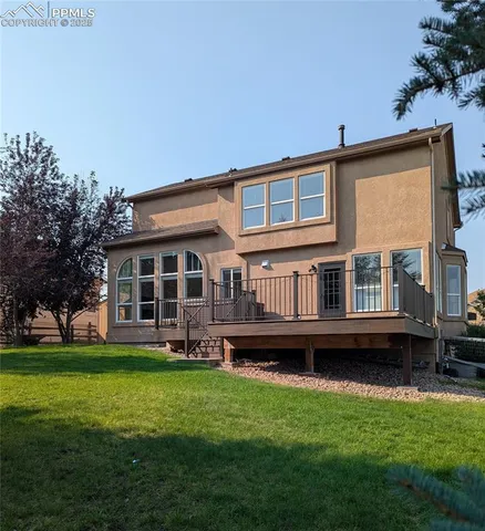 a large house with a yard and plants