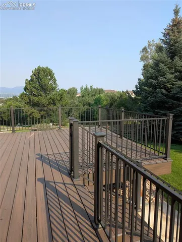 a view of balcony with wooden floor and fence