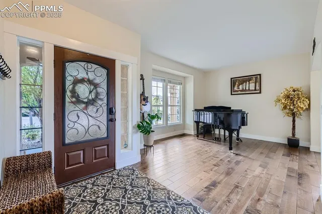 a view of a livingroom with wooden floor and furniture