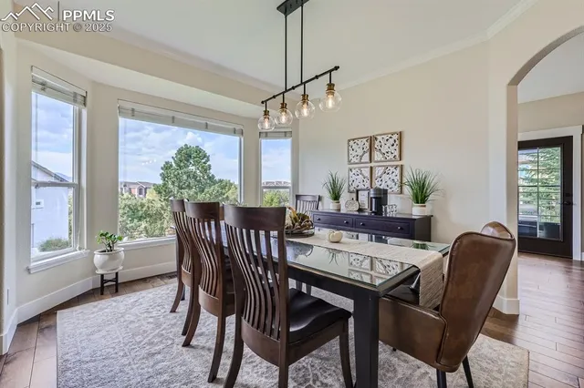 a view of a dining room with furniture window and wooden floor