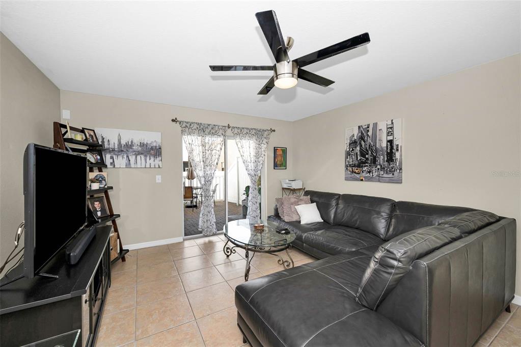 9736 Trumpet Vine Loop Trinity, FL 34655 - Photo 11 of 35 a living room with furniture and a flat screen tv