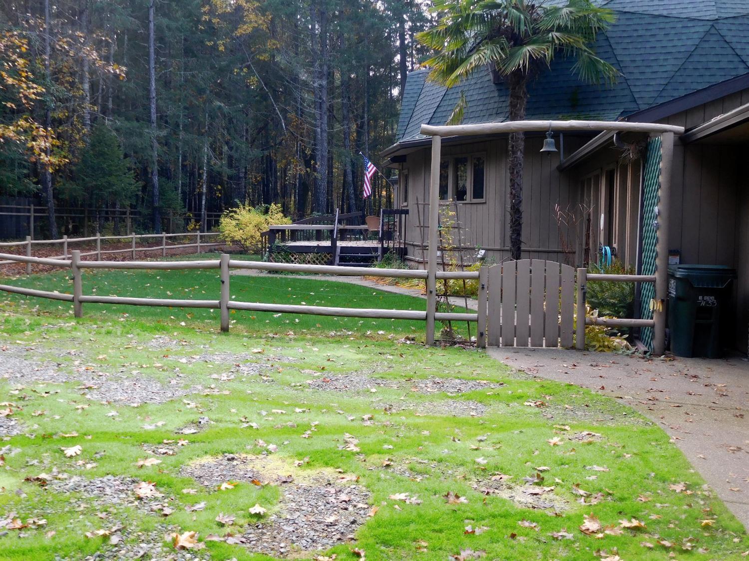 7133 Rockydale Road Cave Junction, OR 97523 - Photo 2 of 23 side view looking across the front lawn