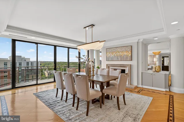 a dining room with furniture window and wooden floor