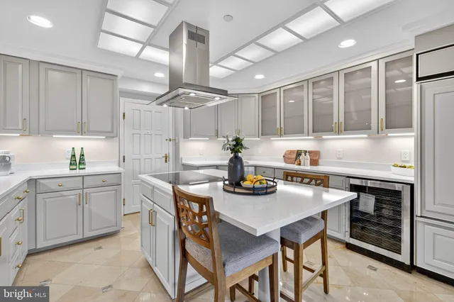 a kitchen with sink a stove and chairs