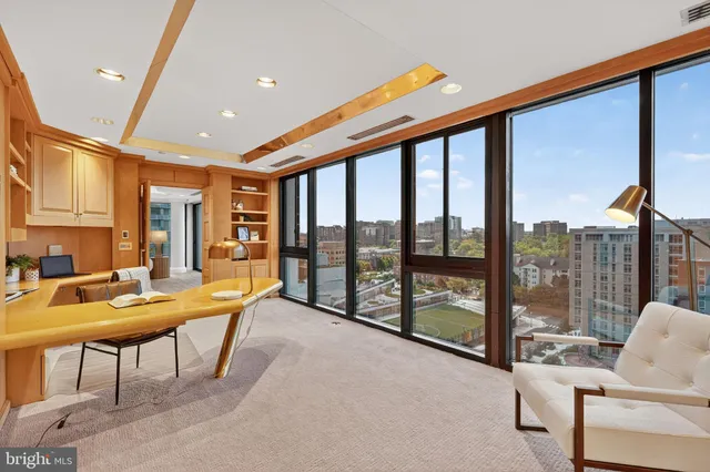 a living room with furniture and a floor to ceiling window