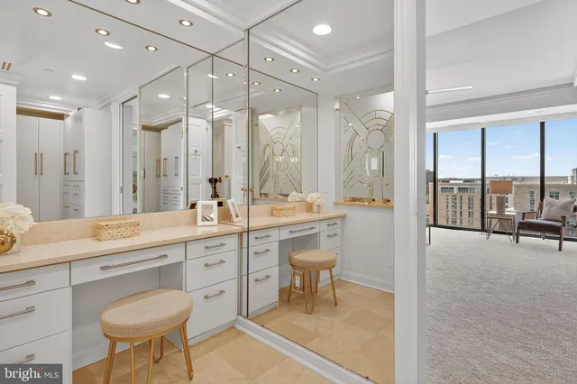 a bathroom with a tub a sink and a large mirror