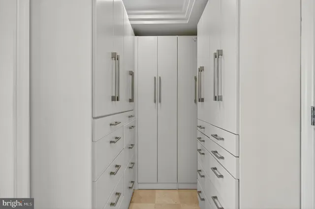 a view of a livingroom with a fireplace large windows and a chandelier