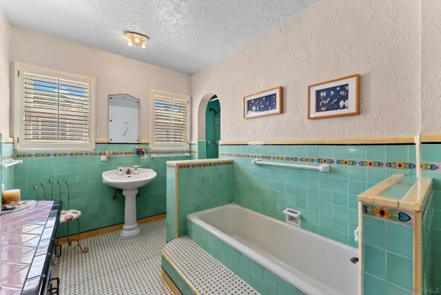 a bathroom with a sink a bath tub and a shower