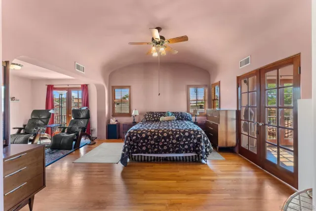 a bedroom with a large bed and a chandelier