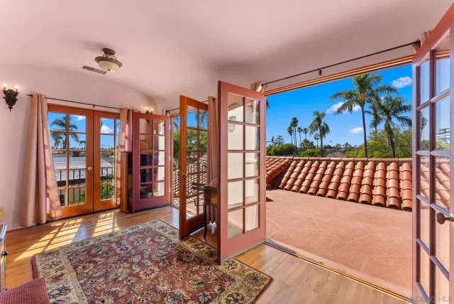 a view of a bedroom with furniture wooden floor and window