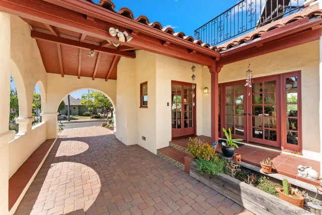 a view of a patio with table and chairs under an umbrella